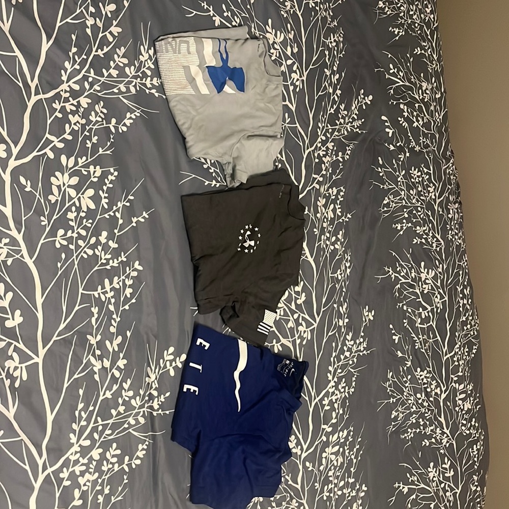 Two under armor, and one Nike boys size large T-shirts